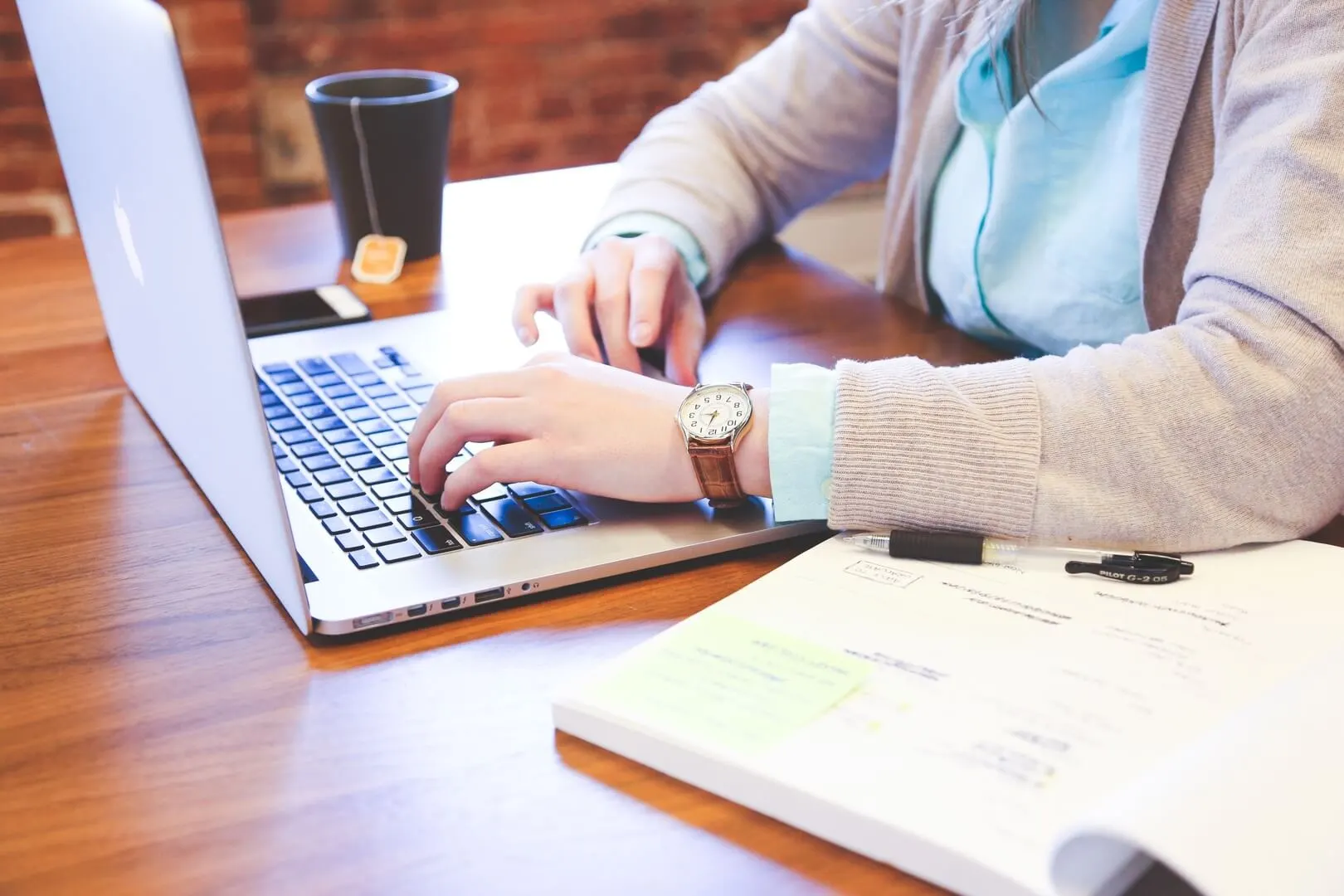 A professional using a laptop at a desk